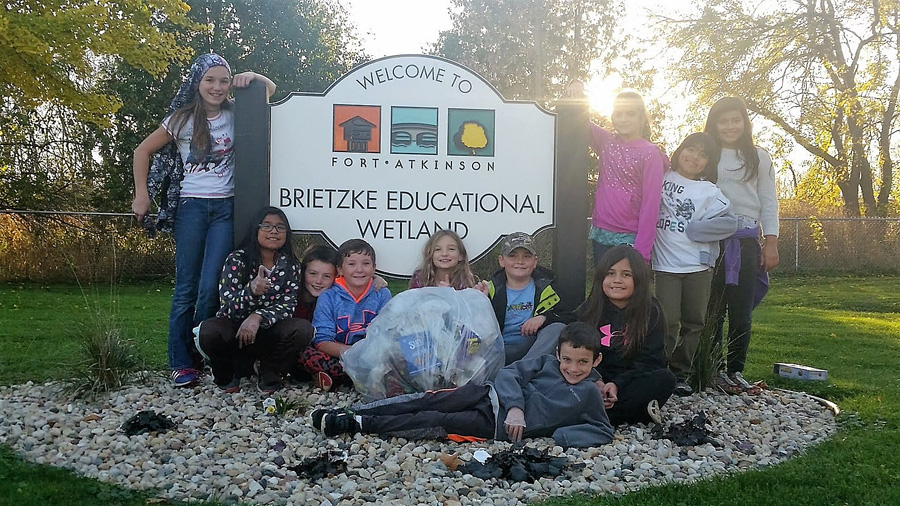 While caring for nearby Brietzke Educational Wetland, teachers and students from the Purdy Elementary School Green Team in Fort Atkinson recycle trash and compost organic materials.  - Photo credit: DNR