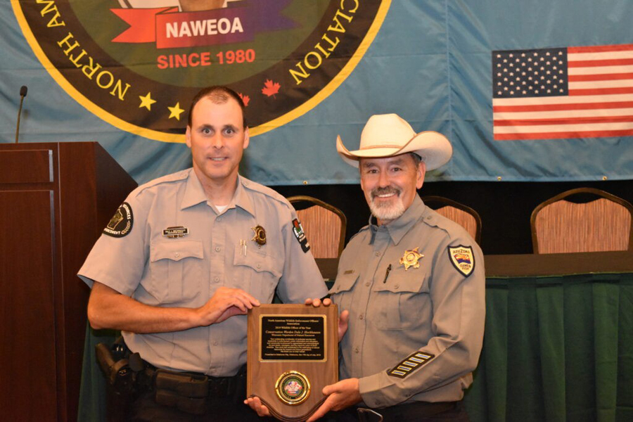 DNR Conservation Warden Dale Hochhausen of the Mississippi River Warden Team with Rick Langley of the North American Wildlife Enforcement Officers Association which named Hochhausen as the association's officer of 2019. - Photo credit: DNR