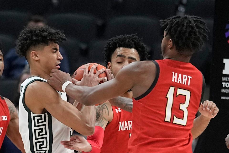 Michigan State&#39;s Max Christie grabs a rebound against Maryland&#39;s Hakim Hart during the second half of their Big Ten tournament game Thursday night. Michigan State held off the Terrapins to advance to a quarterfinal matchup against the second-seeded Wisconsin Badgers.