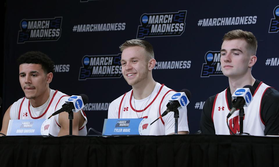 Wisconsin players Johnny Davis, left, Brad Davison and Tyler Wahl speak during a news conference before a practice open to the public Thursday, March 17, 2022 at Fiserv Forum in Milwaukee.