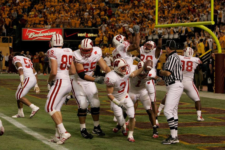 De Pere football coach and former Wisconsin Badgers cornerback Ben Strickland (3) celebrates his blocked punt touchdown against Minnesota on Oct. 15, 2005.