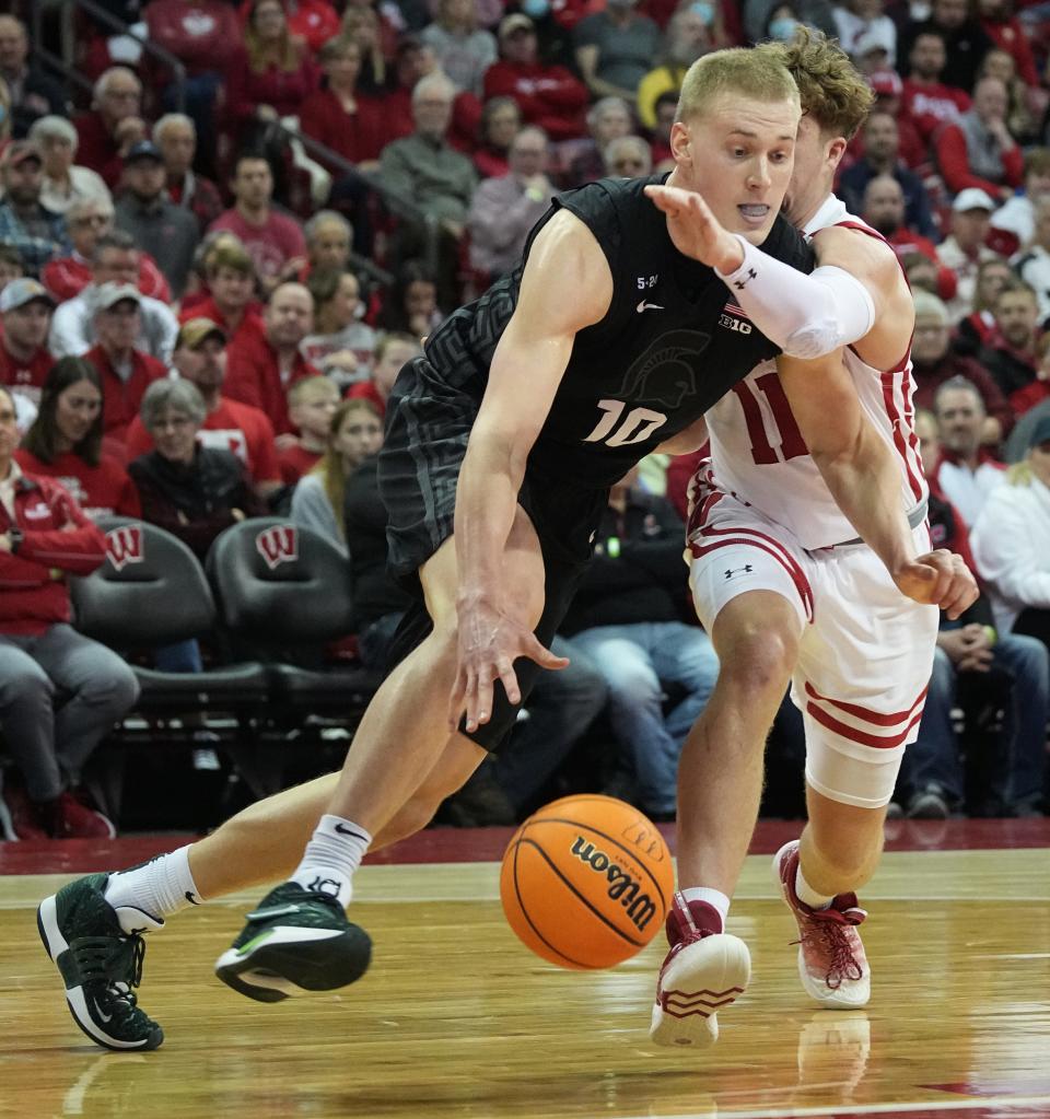 Michigan State forward Joey Hauser (10) Dave past Wisconsin guard Max Klesmit (11) during the first half of their game Tuesday, January 10, 2023 at the Kohl Center in Madison, Wis.