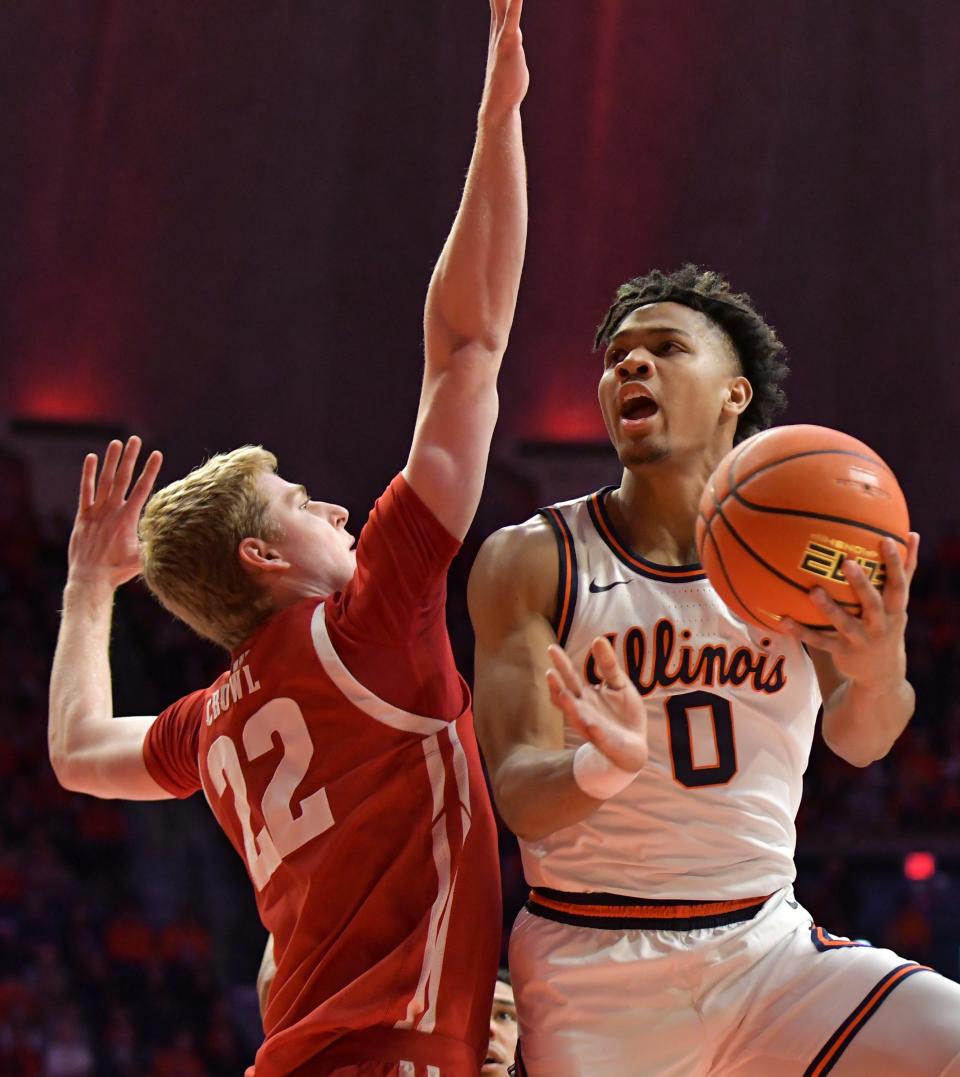 Illinois guard Terrence Shannon Jr. drives to the basket as Wisconsin forward Steven Crowl defends Saturday. Shannon led the Illini with 24 points.