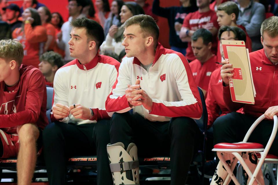 Injured forward Tyler Wahl, right, sits on the Wisconsin bench during the Badgers' loss at Illinois Jan. 7. UW is 0-3 in the three games Wahl has missed with a right ankle injury.