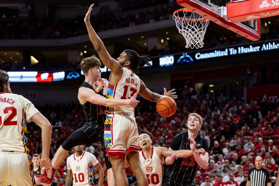 Wisconsin's Max Klesmit wraps a pass to Steven Crowl behind the back of Nebraska's Derrick Walker during the first half  Saturday.