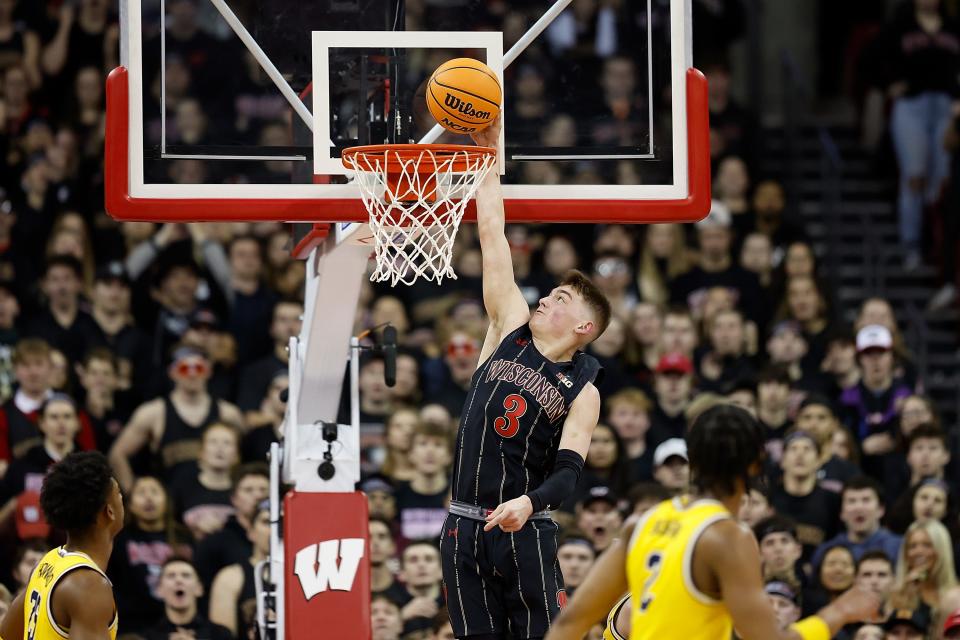 Badgers guard Connor Essegian elevates for a dunk against Michigan during the first half Tuesday night at the Kohl Center in Madison.