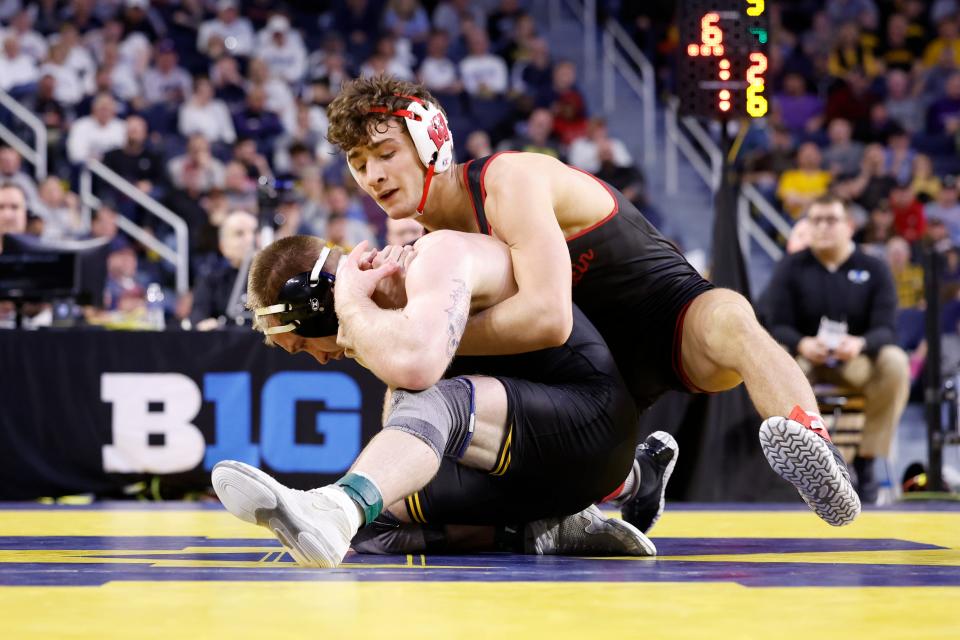 The Badgers' Dean Hamiti wrestles Iowa's Patrick Kennedy in the 165-pound title match in the Big Ten championships Sunday in Ann Arbor, Mich.